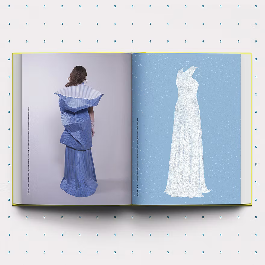 Open book showing a blue dress on the left and a white gown on the right against a light blue background.